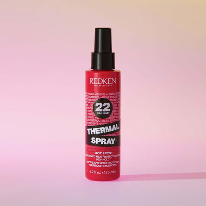 Redken Thermal Spray High Hold 125 mL — bottle on a pink background